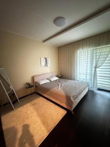 Postel nebo postele na pokoji v ubytování Seaside Forest Residence