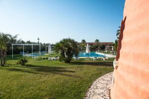 a view of a park with a swimming pool at Masseria La Baronessa Resort in Tuglie