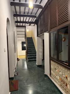 a hallway of a building with a staircase and a stair case at BM Shaw Guest House in Kolkata