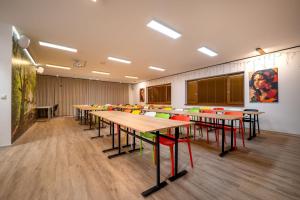 Un aula con mesas y sillas en una habitación. en Dovalovec Resort, en Liptovský Hrádok 38 fotos más