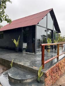 a glass house with a red roof at Cabana Pegasus in Ibicoara