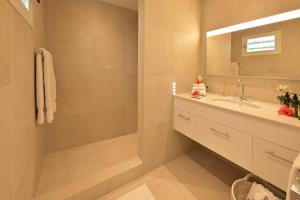 a bathroom with a sink and a mirror at Les Ilets De La Plage in Gustavia