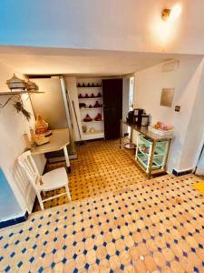 a room with a room with a table and a table and chairs at ROOM iN FES MEDINA in Fès