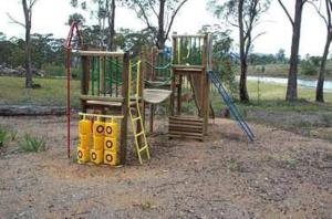 a playground with two swings and a slide at Gumleaves Bush Holidays in Little Swanport