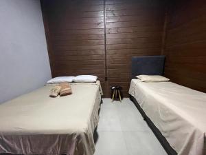 En eller flere senge i et værelse på Microcasa em Itajaí, curta BC e Beto Carrero