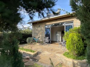a house with a patio and a bike parked outside at Homely Cottage Near Lake Naivasha, Elwai Visitor Centre in Heni Village