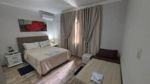 En eller flere senge i et værelse på Casa Alegre Beach House