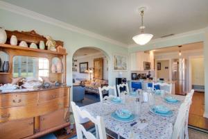 a dining room with a table and chairs and a kitchen at 1 mile to Fort Sill! The CaroleBelle Cottage sleeps 8 with hottub,grills,firepit in Lawton +26 photos