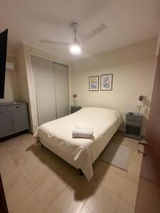 a bedroom with a large white bed in a room at Capibara 7 - Alborada in Corrientes