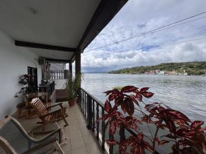 a balcony with a view of a body of water at La Posada De Don Jose in Flores