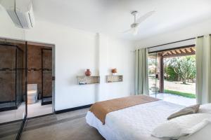 En eller flere senge i et værelse på Pousada Ganesha Búzios