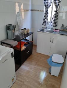 a small kitchen with a sink and a counter at Cozy cabin for 4 people San Pedro de Atacama in San Pedro de Atacama