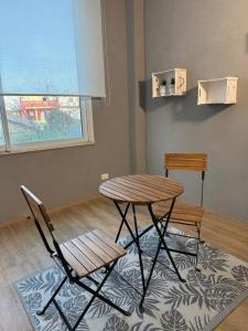 a table and two chairs in a room at Inn Puglia Guest House 2 in Acquaviva delle Fonti