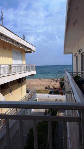 a view of the ocean from a balcony of a building at Jacob's House in Néa Péramos