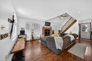 a living room with a couch and a fireplace at Private Pocono Retreat with Hot Tub and Fire Pit in Thornhurst
