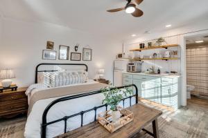 a bedroom with a bed and a table and a kitchen at 4- Sequatchie Cottage in Lookout Mountain