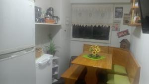 a small kitchen with a wooden table with flowers on it at Apartamento Costanera in Punta Arenas +1 photo