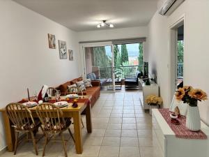 a living room with a table and a couch at Large apartment in an idyllic complex, ocean view in Mandria