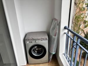 a washing machine in the corner of a stairway at Large apartment in an idyllic complex, ocean view in Mandria