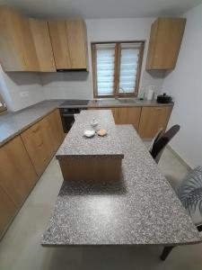 a kitchen with a table in the middle of it at Casa de vacanta Gea Transalpina in Şugag +10 photos