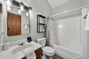 a bathroom with a sink and a toilet and a mirror at Private Pocono Retreat with Hot Tub and Fire Pit in Thornhurst +50 photos
