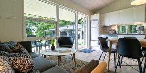 a living room with a couch and a table at Husodde Strand Camping & Cottages in Horsens
