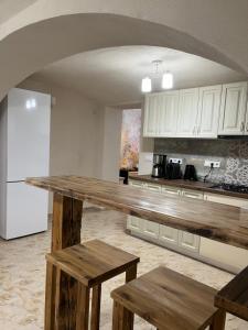 a kitchen with a counter and a white refrigerator at CASA CIUC in Sibiu