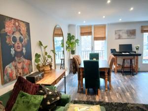 a living room with a table and a piano at Contractors LONG TERM BOOKINGS in London +12 photos
