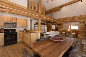 a kitchen and dining room with a wooden table at Powder Ridge Cabin - 9A Red Cloud in Big Sky