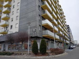 a large apartment building with a parking lot at Łąkowa 7 Apartamenty LUNA Białystok in Skorka