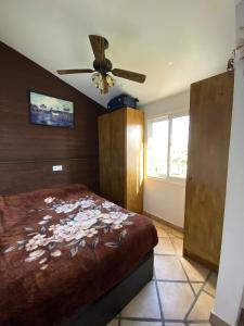 a bedroom with a bed and a ceiling fan at Casa Tesoreta in Cala en Forcat
