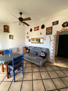 a living room with a couch and a table at Casa Tesoreta in Cala en Forcat