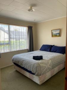 Ένα ή περισσότερα κρεβάτια σε δωμάτιο στο Tranquil Tides