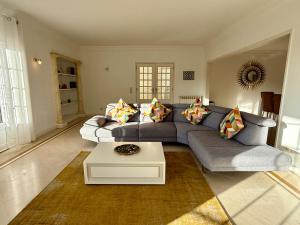 a living room with a couch and a coffee table at Serenity Cascais Villa in Cascais +50 photos