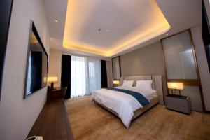 a bedroom with a large bed and two lamps at ESP Hotel in Accra +18 photos