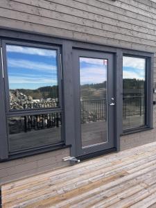 a room with three windows on a wooden deck at Modern Flat In Flateby in Lii