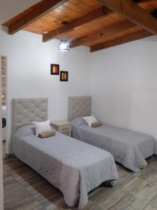 Ένα ή περισσότερα κρεβάτια σε δωμάτιο στο Garage y Patio Privado en La Falda