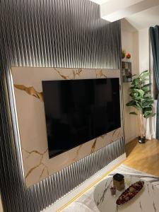 a large flat screen tv on a wall at Acon Heights in London