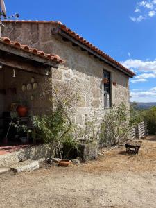 a building with a bench in front of it at Herdade de Açores in Aldeia Rica