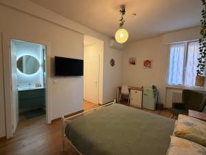 a living room with a bed and a television at B&B Sunny's House in Bologna