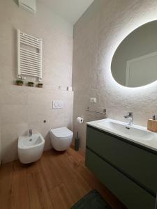 a bathroom with a sink and a toilet and a mirror at B&B Sunny's House in Bologna +7 photos