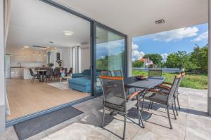 a dining room and living room with a table and chairs at Holiday House Omis - Naklice in Omiš