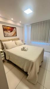 Ένα ή περισσότερα κρεβάτια σε δωμάτιο στο Israel Flat com vista para o mar na orla de Tambaú