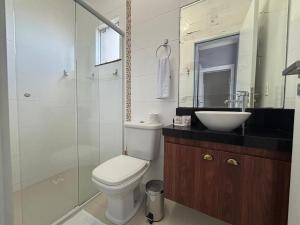 Un baño con inodoro, lavabo y ducha. en Dúplex con impresionantes vistas al mar RAT002, en Perequê 11 fotos más