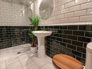 een badkamer met toilet, wastafel en bad bij Quarry Barn in Gresford +42 foto's