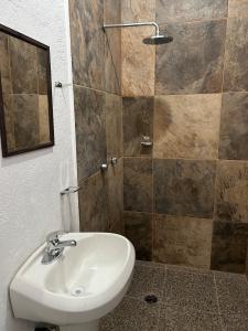 a bathroom with a sink and a shower at Casa Regina in Tepoztlán