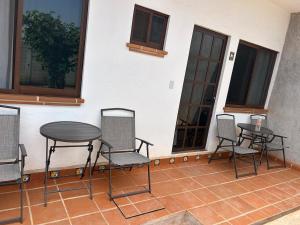 a group of chairs and a table on a patio at Casa Regina in Tepoztlán