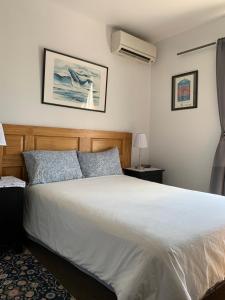 a bedroom with a large white bed with blue pillows at Pensione Popolo in Montreal +47 photos