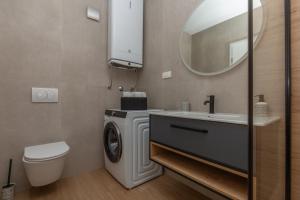 a bathroom with a washing machine and a sink at Holiday House Omis - Naklice in Omiš +32 photos