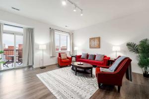 ein Wohnzimmer mit zwei roten Stühlen und einem Tisch in der Unterkunft Spacious 3BR Urban Getaway w Gym in Chicago